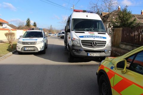 Rendőrautók és mentőorvos a tatabányai gyerekgyilkosság helyszínén.