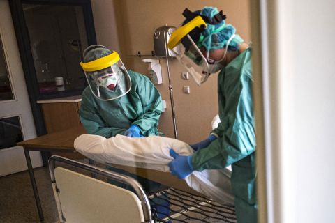 Védőfelszerelést viselő nővérek egy kórtermet készítenek elő a koronavírussal érintett új betegek fogadására kialakított egyik osztályon a fővárosi Szent László Kórházban 2020. március 16-án.