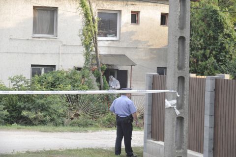 Bűnügyi helyszínelő és rendőr kordonszalaggal lezárt ház előtt Érden 2020. augusztus 8-án, ahol az épületben holttestet találtak.