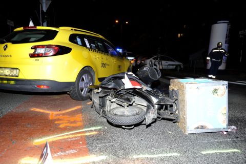 Összetört segédmotoros kerékpár egy taxi mellett a II. kerületi Kacsa utca és a Horvát utca kereszteződésében 2020. november 10-én, miután az autó és a robogó összeütközött.