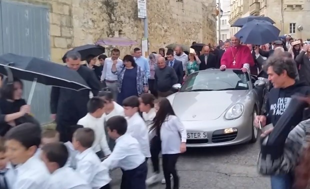 Gyerekek vontatta Porschén érkezett az új pap Máltán – videó