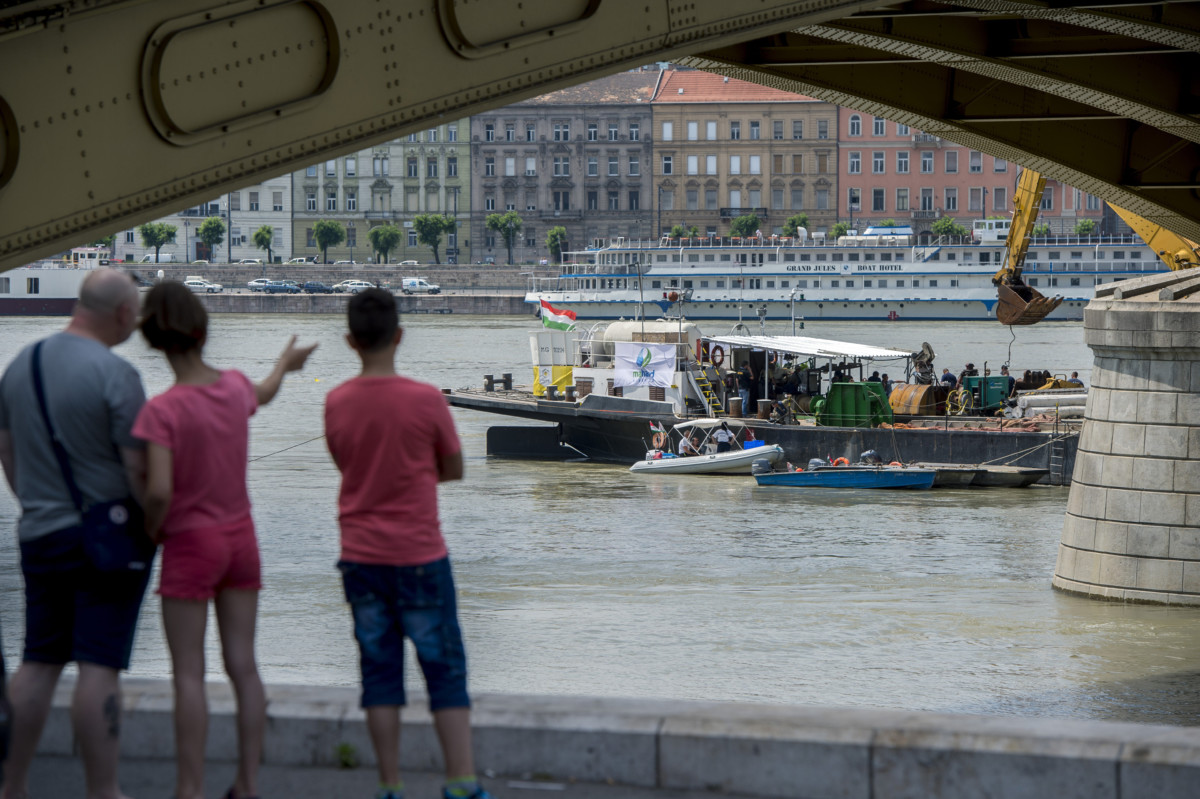 A roncs kiemelését előkészítő szakemberek a balesetben elsüllyedt Hableány turistahajó közelében, a Margit hídnál horgonyzó uszályon 2019. június 10-én.