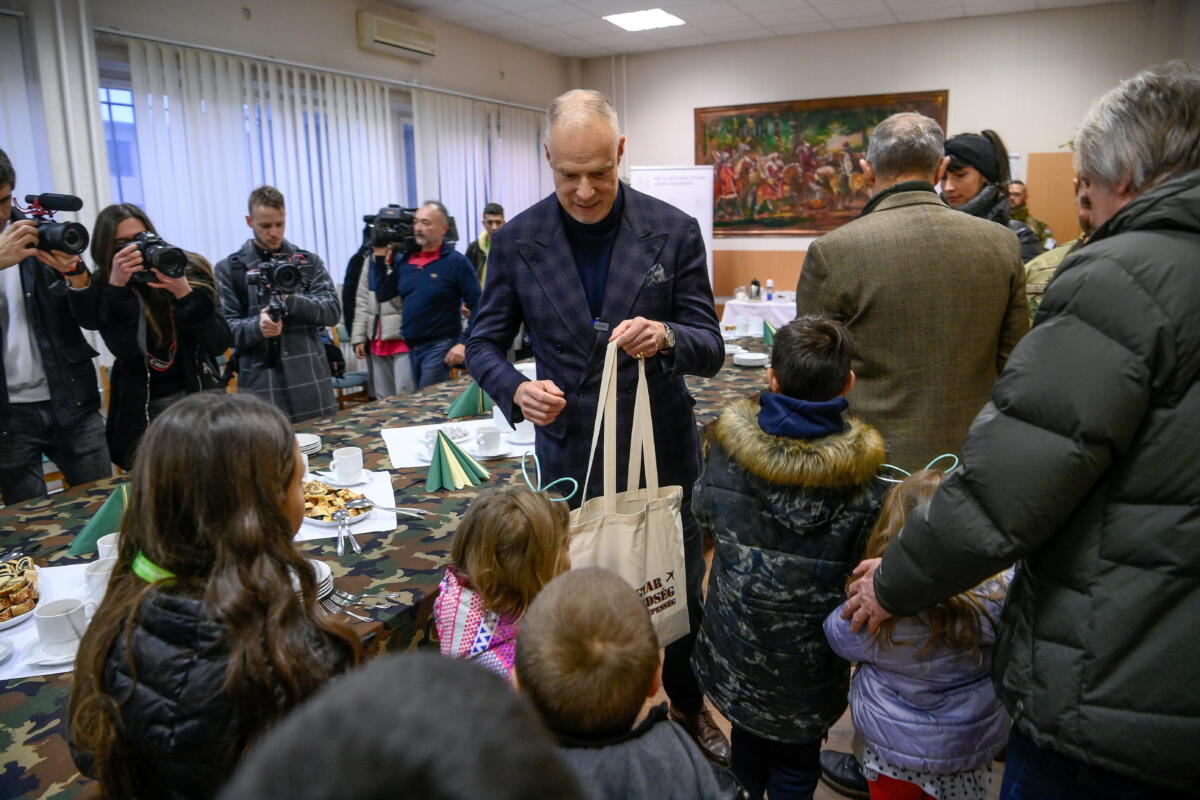 Szalay-Bobrovniczky Kristóf honvédelmi miniszter (k) ajándékokat ad át a nyírteleki Kedvesház diákjainak az MH 5. Bocskai István Lövészdandár debreceni laktanyájában 2022. december 20-án.